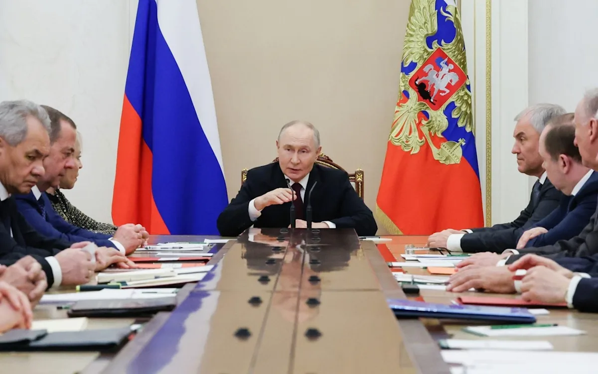 A descriptive image of a person holding a tablet with a red 'off switch' symbol, symbolising Russia's internet censorship, with a cityscape in the background, highlighting the potential consequences of Putin's plan on internet freedom