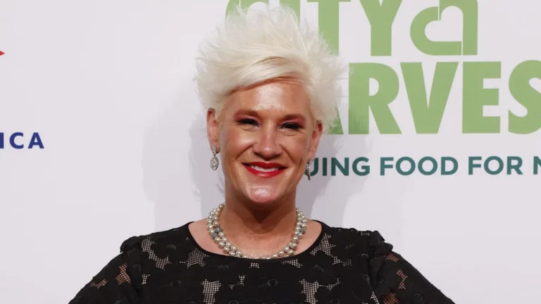 A photograph of Anne Burrell, with a subtle background colour scheme, highlighting the importance of mental health and wellbeing in the wake of her tragic death, with a focus on the primary keyword phrase 'Anne Burrell investigation'