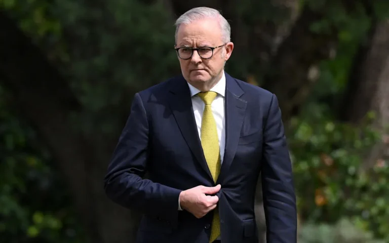 Australian prime minister being evacuated from home to secure location due to security concerns, with police and security personnel present, highlighting the importance of safety measures for high-profile individuals
