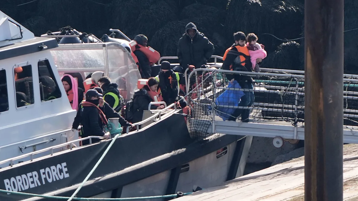 A group of migrants arriving on the shores of the UK, having crossed the English Channel in a small boat, with a mix of relief and uncertainty on their faces, highlighting the challenges and complexities of migrant crossings