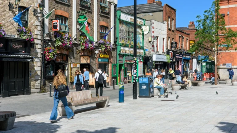 A sombre and reflective image of Temple Bar, with a memorial for the UK tourist who was murdered, highlighting the tragic incident and the need for justice, with a focus on the murder investigation