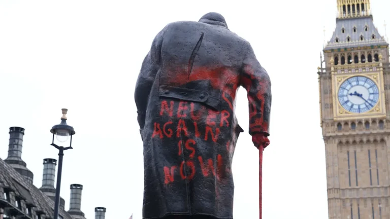 The Winston Churchill statue defaced with graffiti, a shocking display of destructive behaviour and vandalism, highlighting the need for increased security measures to protect public monuments and preserve history