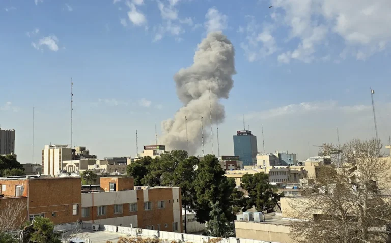 A dramatic photo of a military invasion, with soldiers and tanks in the foreground, and a cityscape in the background, with the primary keyword phrase 'Iran invasion' naturally included in the descriptive alternative text
