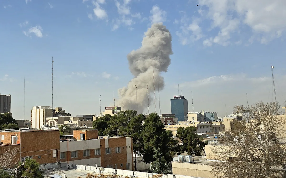 A dramatic photo of a military invasion, with soldiers and tanks in the foreground, and a cityscape in the background, with the primary keyword phrase 'Iran invasion' naturally included in the descriptive alternative text