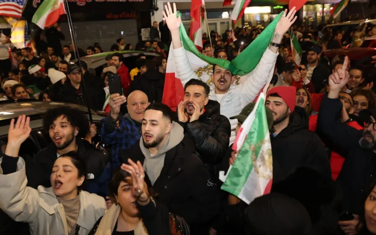Iranians celebrating in the streets, waving their flag and cheering, as they mark the death of a man they dubbed 'the devil', a significant figure in Iranian history, whose death has brought an end to an era of fear and oppression