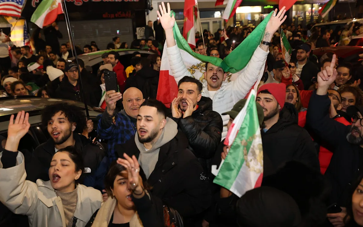 Iranians celebrating in the streets, waving their flag and cheering, as they mark the death of a man they dubbed 'the devil', a significant figure in Iranian history, whose death has brought an end to an era of fear and oppression