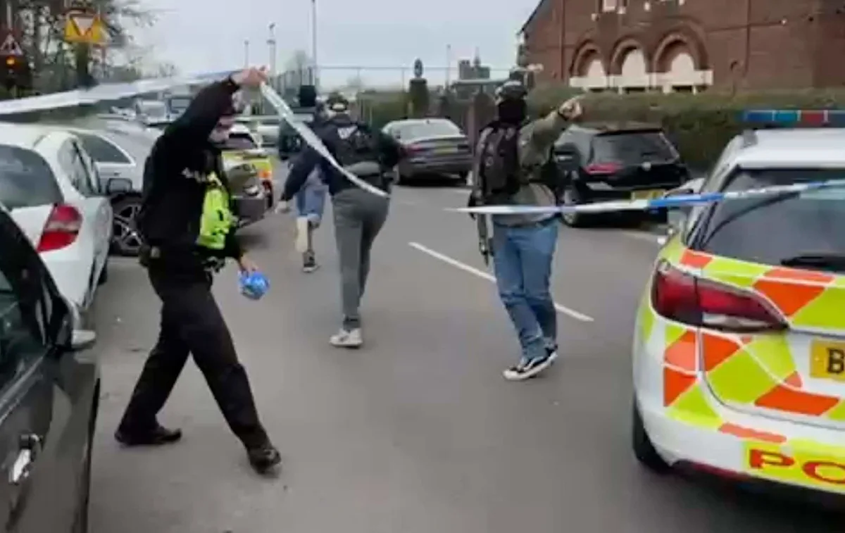 A photo of a police cordon near a primary school, with officers investigating a stabbing incident, highlighting the importance of counter-terror efforts and community safety, with a focus on the primary keyword phrase counter-terror police