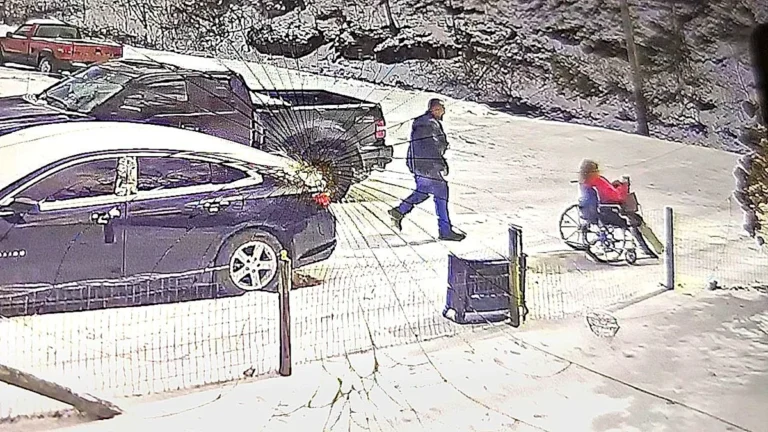 A descriptive image of a couple laughing and embracing, with a wheelchair in the background, highlighting the importance of finding humour in difficult situations and promoting disability awareness and inclusivity