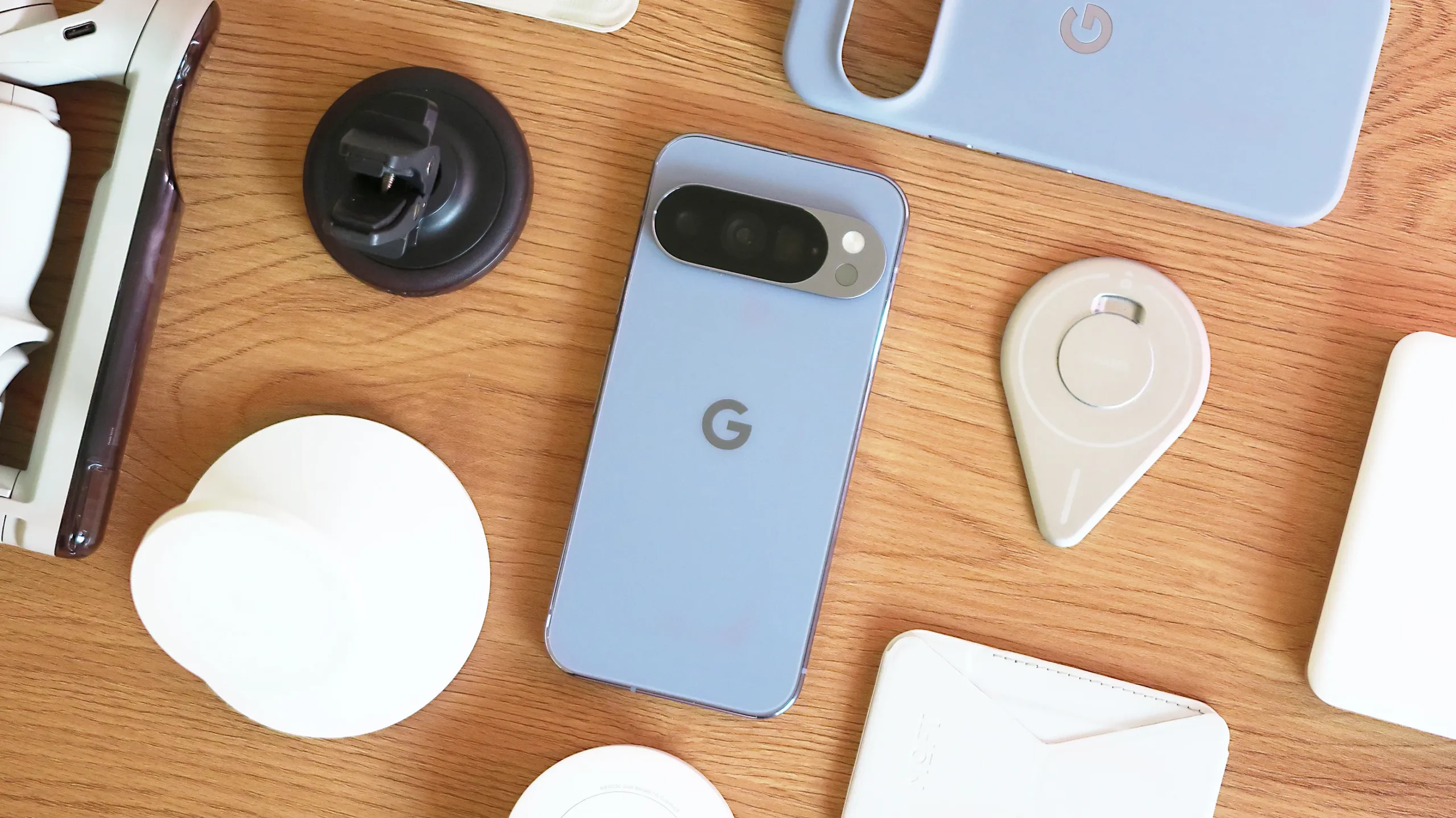 Google Pixel phone with Circle to Search feature, showcasing multi-object image recognition and Try It On button, with a UK cityscape in the background, highlighting the latest March Pixel Drop features