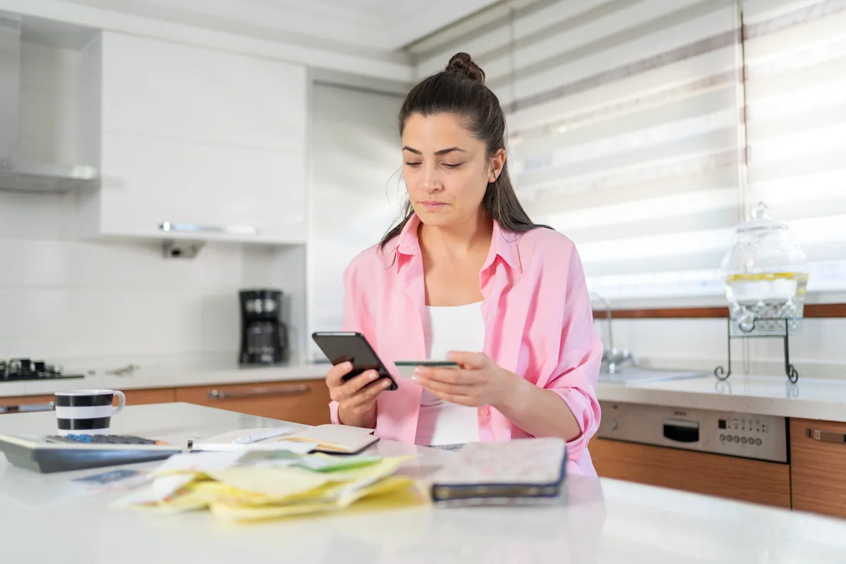 A person looking at a computer screen with a concerned expression, surrounded by papers and documents related to DWP benefits, with a caption that reads 'DWP benefits claim changes'