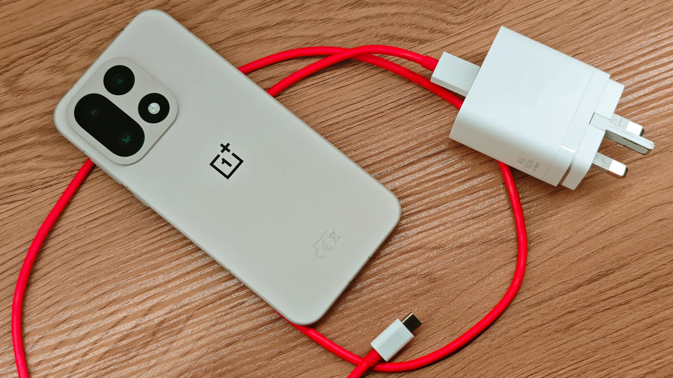The OnePlus 15T features a massive 7500mAh Glacier Battery, supporting 100W wired and 50W wireless charging, with bypass charging and waterproofing certification, making it a top contender in the UK smartphone market