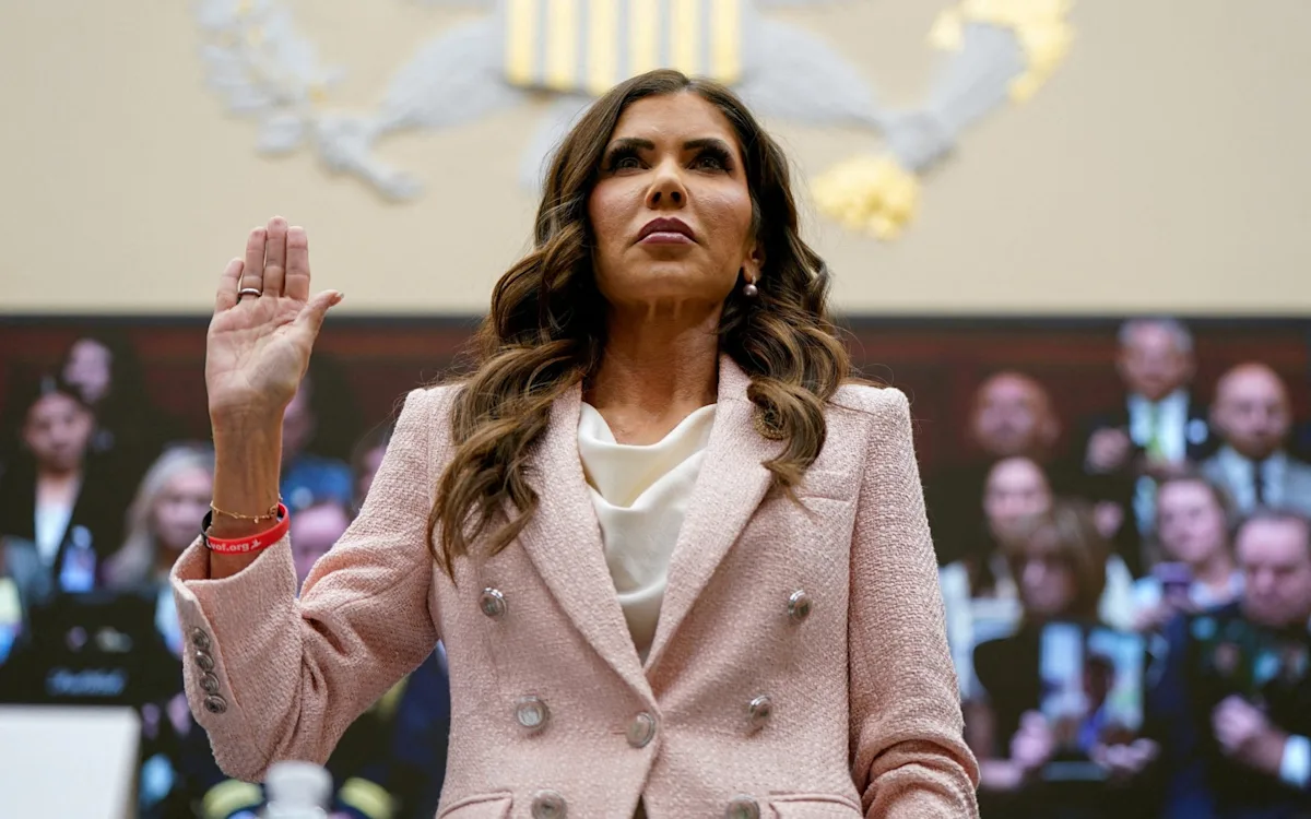 US President Donald Trump and former Homeland Security Secretary Kristi Noem in a meeting, discussing national security and border control, with a focus on the colour and complexity of US politics