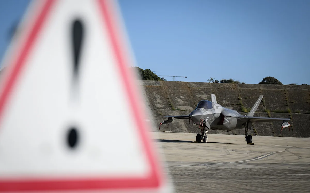 Aerial view of the RAF base in Cyprus, with a drone flying in the background, highlighting the recent drone strike and its impact on the base's security