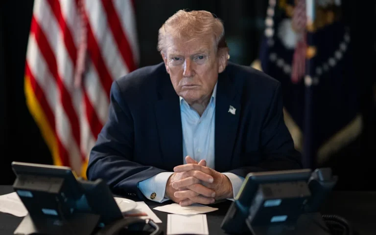 Image of Trump speaking at a press conference, with a stern expression, surrounded by reporters and cameras, highlighting the tension and uncertainty surrounding his demands for unconditional surrender, a key aspect of international relations and diplomacy
