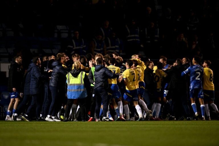 Colchester and Gillingham football teams in confrontation