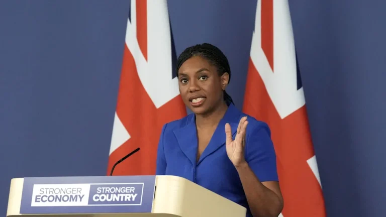 Defence Secretary Badenoch speaking at a podium, with a Royal Air Force flag in the background, highlighting her commitment to the RAF and defence spending