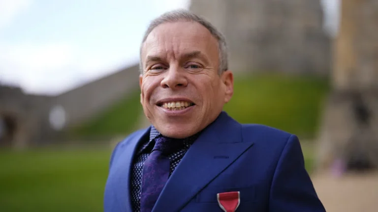 Warwick Davis celebrates his OBE with his two children and a mystery companion, sparking speculation about their relationship and leaving fans eager to learn more about the enigmatic individual
