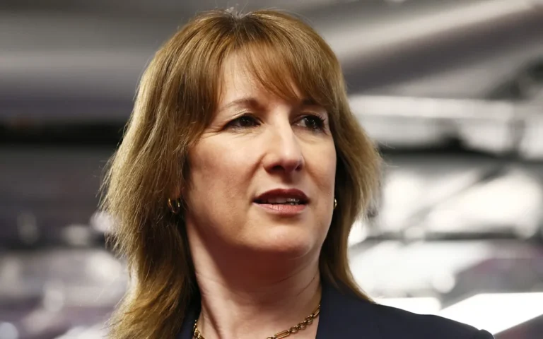 A family sitting together in a warm and cozy living room, with a fireplace burning in the background, thanks to Reeves' help with their heating oil bills, providing them with a sense of security and comfort