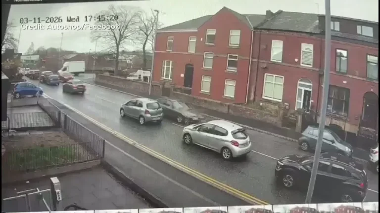 A damaged police van and parked cars after a collision on a road, with debris scattered all over the road, highlighting the importance of road safety and responsible driver behaviour, particularly in emergency situations.