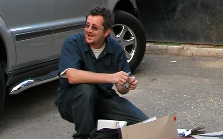 A descriptive image of Banksy's artwork, with a focus on the street artist's use of colour and vibrancy to convey his message, as revealed in the 25-year-old arrest record, which has shed new light on the artist's behaviour and commitment to anonymity