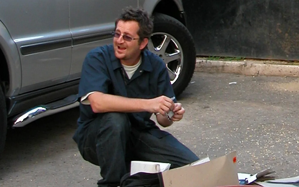 A descriptive image of Banksy's artwork, with a focus on the street artist's use of colour and vibrancy to convey his message, as revealed in the 25-year-old arrest record, which has shed new light on the artist's behaviour and commitment to anonymity