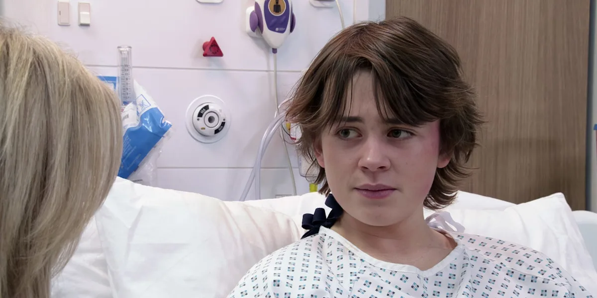 A dramatic scene from Coronation Street, featuring Sam and Megan, with a dark and ominous colour palette, reflecting the intense and suspenseful mood of the storyline, as the characters' behaviour and motivations are put to the test