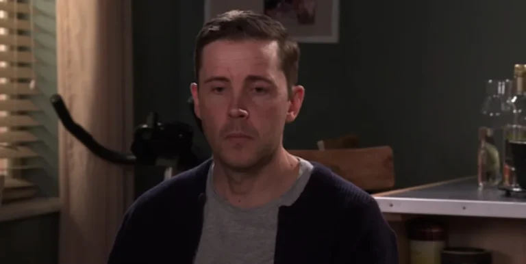 A dramatic scene from Coronation Street featuring Todd, with a shocked expression on his face, as the wedding plot takes a dark turn, with the iconic cobbles and familiar faces of Weatherfield in the background, showcasing the show's unique blend of colour and atmosphere