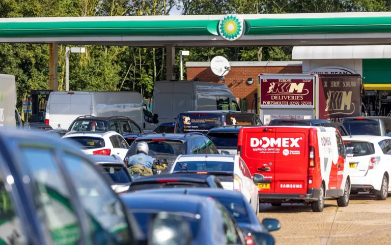 A petrol pump with a sign indicating a fuel shortage, as motorists panic buy fuel amidst the UK's petrol shortage crisis, with the primary keyword being petrol shortage
