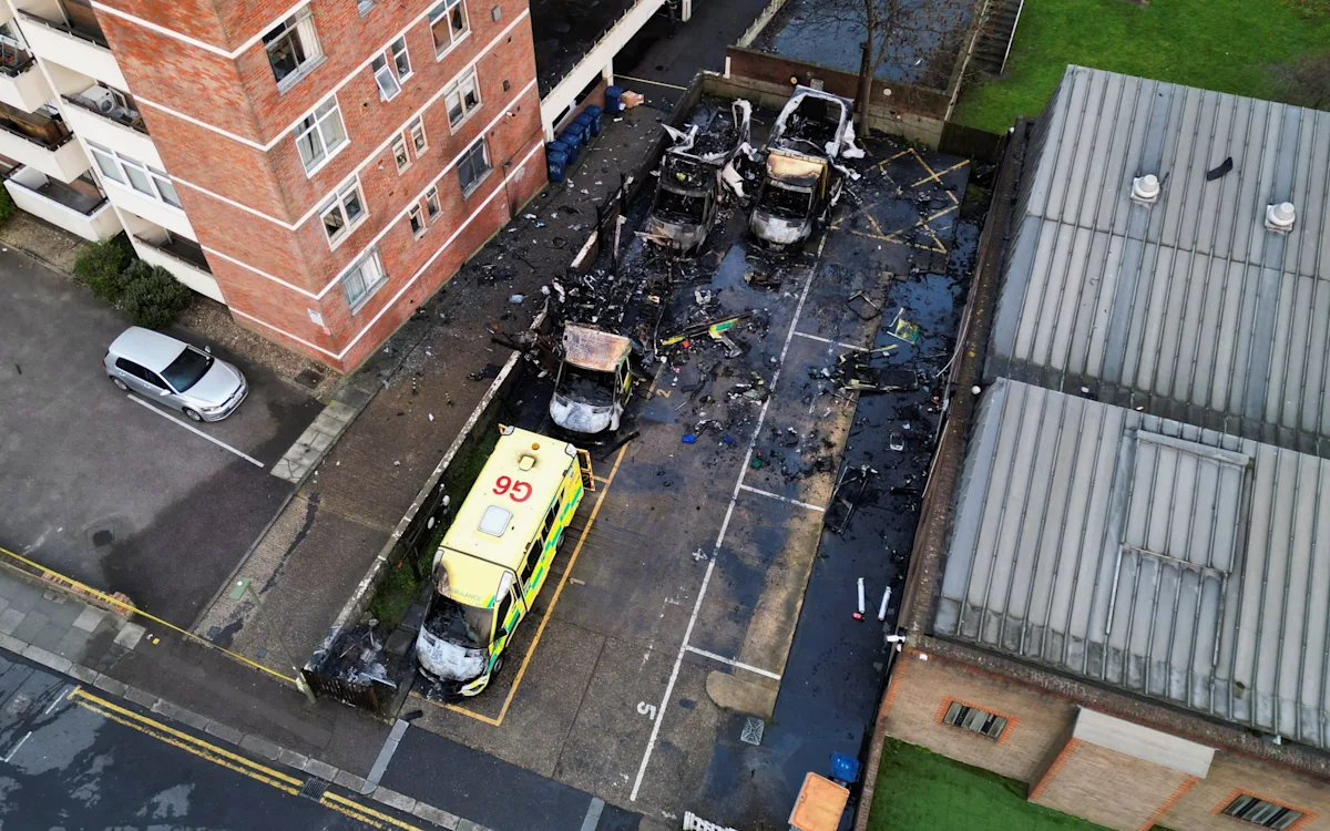 A burning ambulance, a symbol of the rising trend of hate crimes, with a focus on anti-Semitic attacks and the importance of community cohesion and tolerance, as people come together to support the affected emergency responders