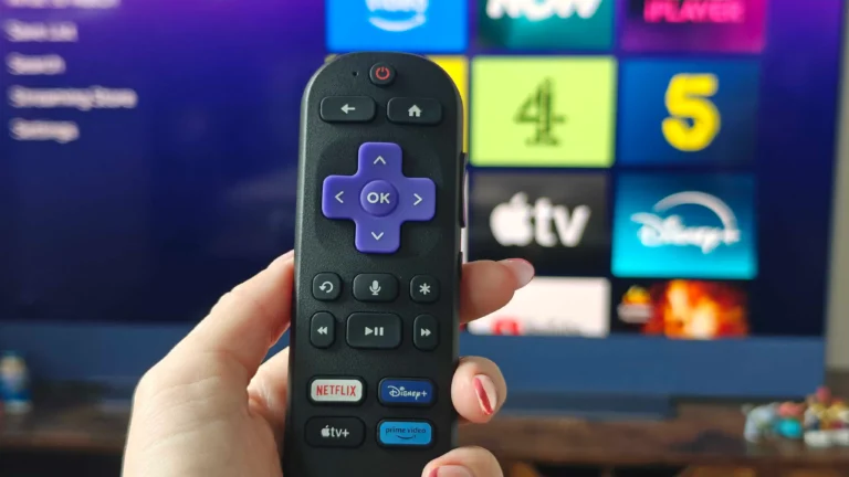 A person holding a Roku remote control, with a TV screen displaying a streaming service in the background, showcasing the best of UK streaming with Roku