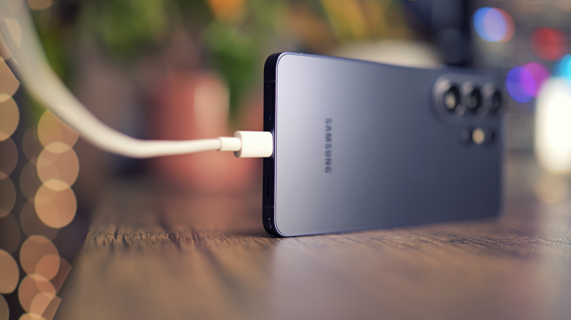 Samsung Galaxy S26 Ultra phone with wireless charging pad, illustrating the issues with the phone's 25W wireless charging support in the UK