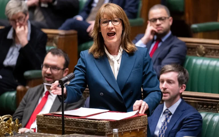 A family sitting in a living room with a worried expression, looking at a high energy bill, with a caption 'middle classes set to miss out on Reeves energy bill support'