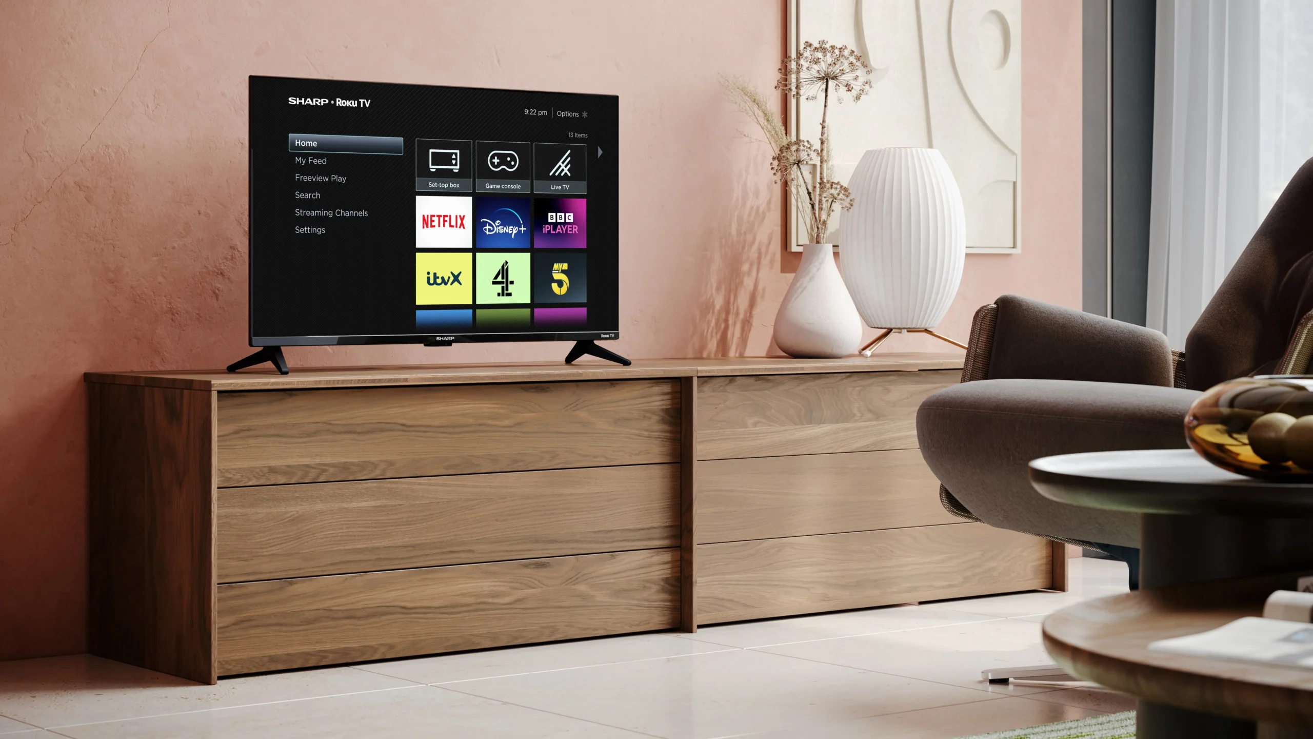 Roku UK Expands Free Channel Lineup with 5 New Additions 1 A Roku TV device with a range of free channels available, including The Graham Norton Show and Hell's Kitchen, with a UK flag in the background, representing the expansion of Roku's free channel lineup in the UK, with a focus on streaming and TV shows