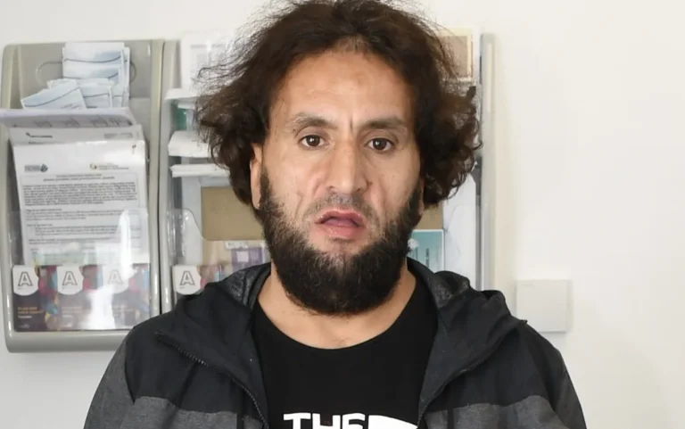 A sombre and reflective image of a prison cell, with a focus on the harsh colour and stark reality of the environment, highlighting the need for increased security measures and support for prisoners and staff, in relation to the terrorist attack and assault on prison staff for Gaza