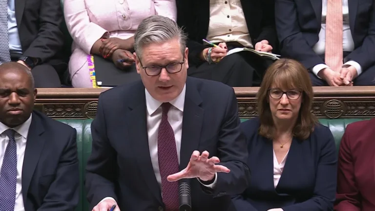Keir Starmer speaking in parliament, with a caption discussing the cost of living crisis and benefit recipients, highlighting the need for effective economic policy to support all members of society