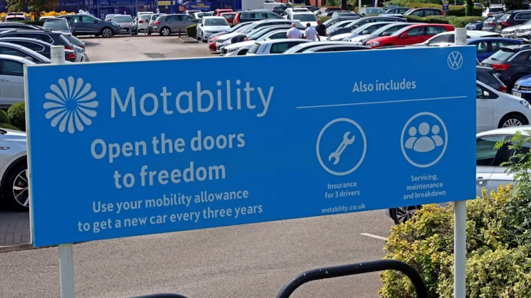 A disabled person in a wheelchair getting into a Motability scheme vehicle, with a concerned expression on their face, highlighting the impact of tax hikes on disabled Motability scheme users and the importance of preserving the scheme