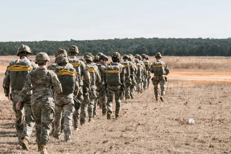 A descriptive image of the Iranian flag, symbolising the country's rich history and culture, with a subtle background of military personnel and equipment, highlighting the potential consequences of US military deployment in the region, with the primary keyword 'Iran conflict' featured prominently.