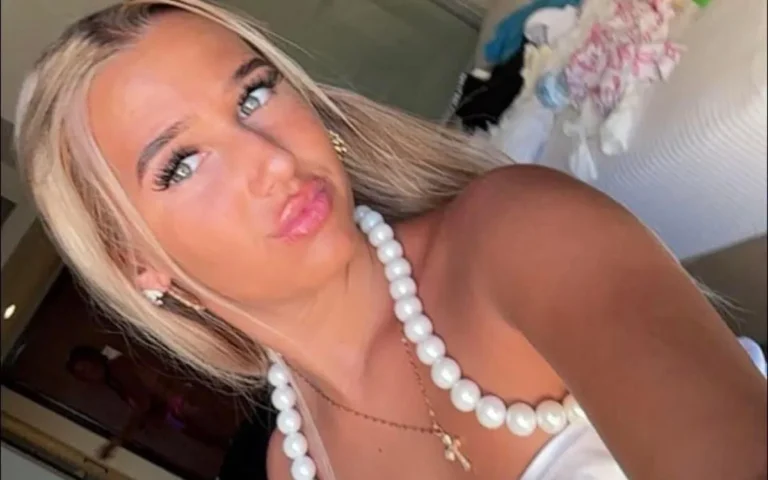 A teenage girl is comforted by friends and family after a tragic incident, with the primary keyword phrase teenage disputes being highlighted as a major concern in the community, with the colour of the community being dulled by this incident