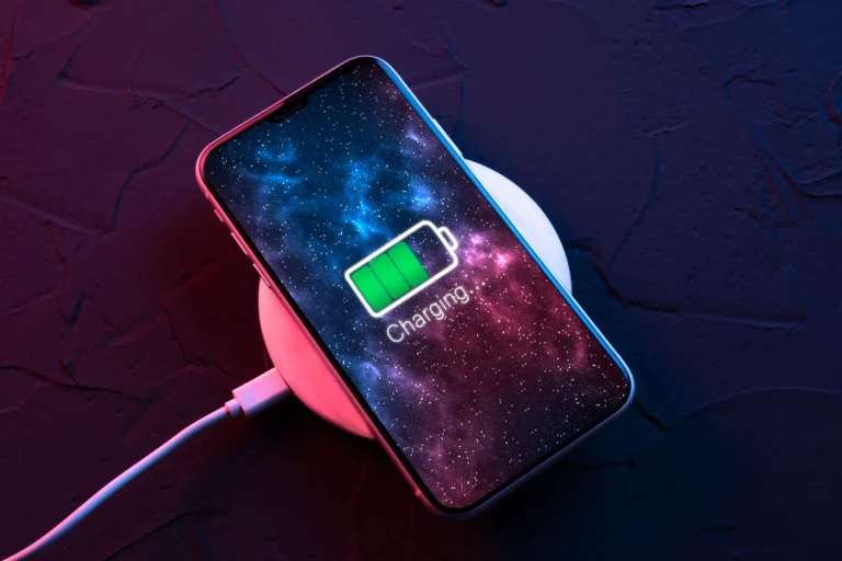 An image of a smartphone being charged, with a clock in the background, representing the fast charging capabilities of Android 17's Priority Charging mode, which will be available in the UK