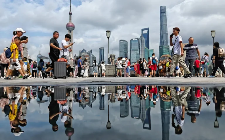 A person holding a smartphone with a Chinese flag in the background, symbolising the influence of China on social media and the importance of media literacy in navigating online content