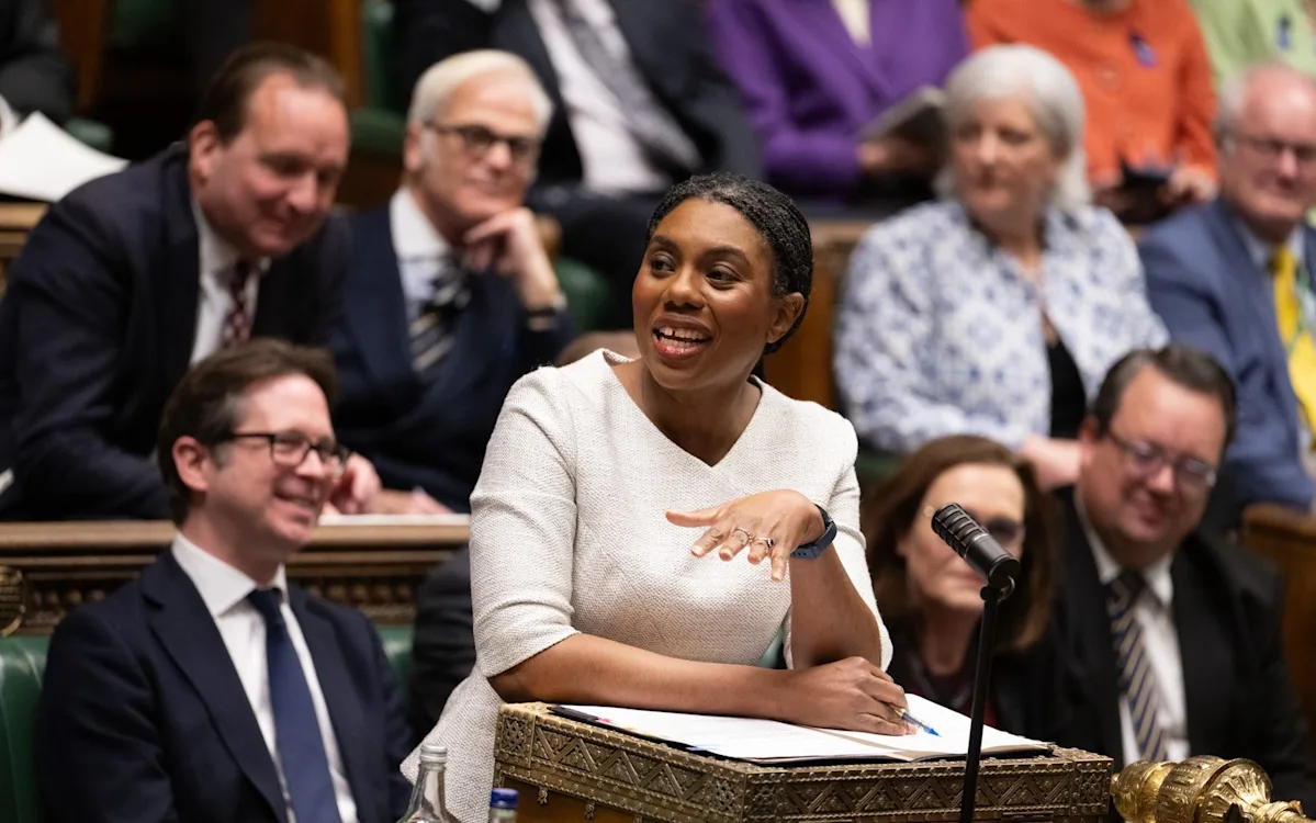 A family sitting around a table with a calculator and bills, looking concerned about their finances, with a caption describing the benefits boost for jobless families and the tax bomb hitting the middle class, including the primary keyword benefits boost