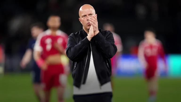 A packed Anfield stadium with fans cheering on Liverpool in a Champions League match, highlighting the team's passionate supporters and the primary keyword, Champions League