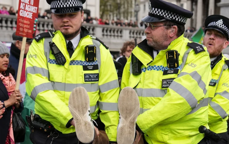 A group of protesters holding signs and banners during the Palestine Action protest, with a focus on the primary keyword phrase Palestine Action