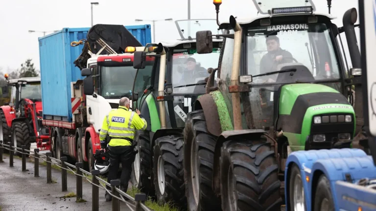 A group of protesters holding placards and banners, demonstrating against the rising fuel prices in the UK, with a clear focus on the primary keyword phrase fuel price protests