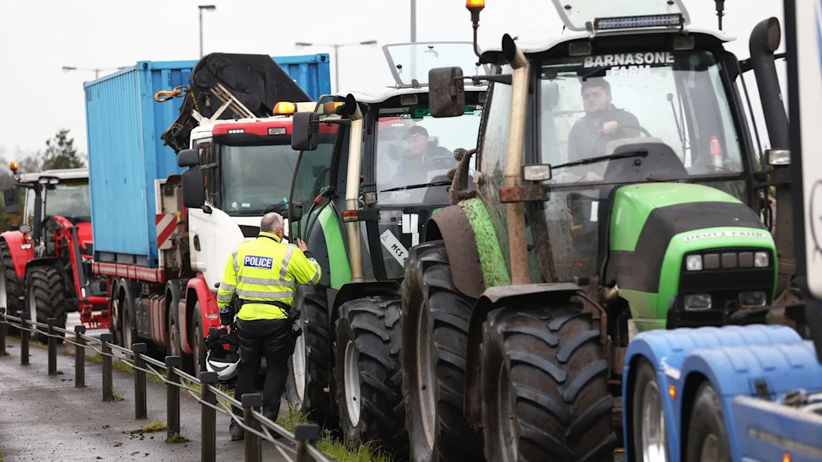 A group of protesters holding placards and banners, demonstrating against the rising fuel prices in the UK, with a clear focus on the primary keyword phrase fuel price protests
