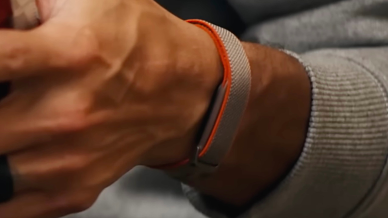 Fitbit's new screenless band, featuring a woven-style design in grey and orange, with a slim profile and advanced features for fitness tracking in the UK