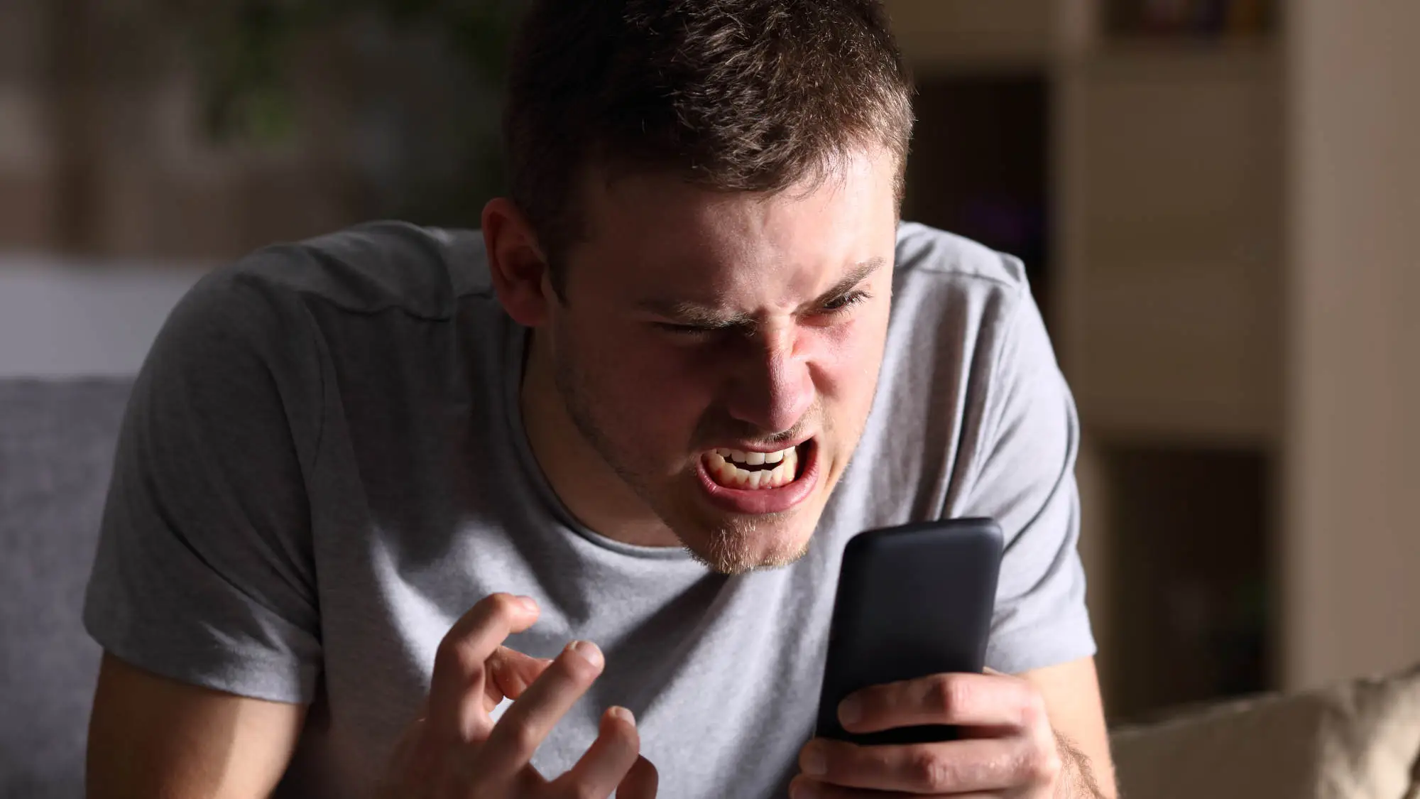 A person holding a Samsung phone with a disappointed expression, with a cityscape in the background, representing the search for alternative smartphones in the UK
