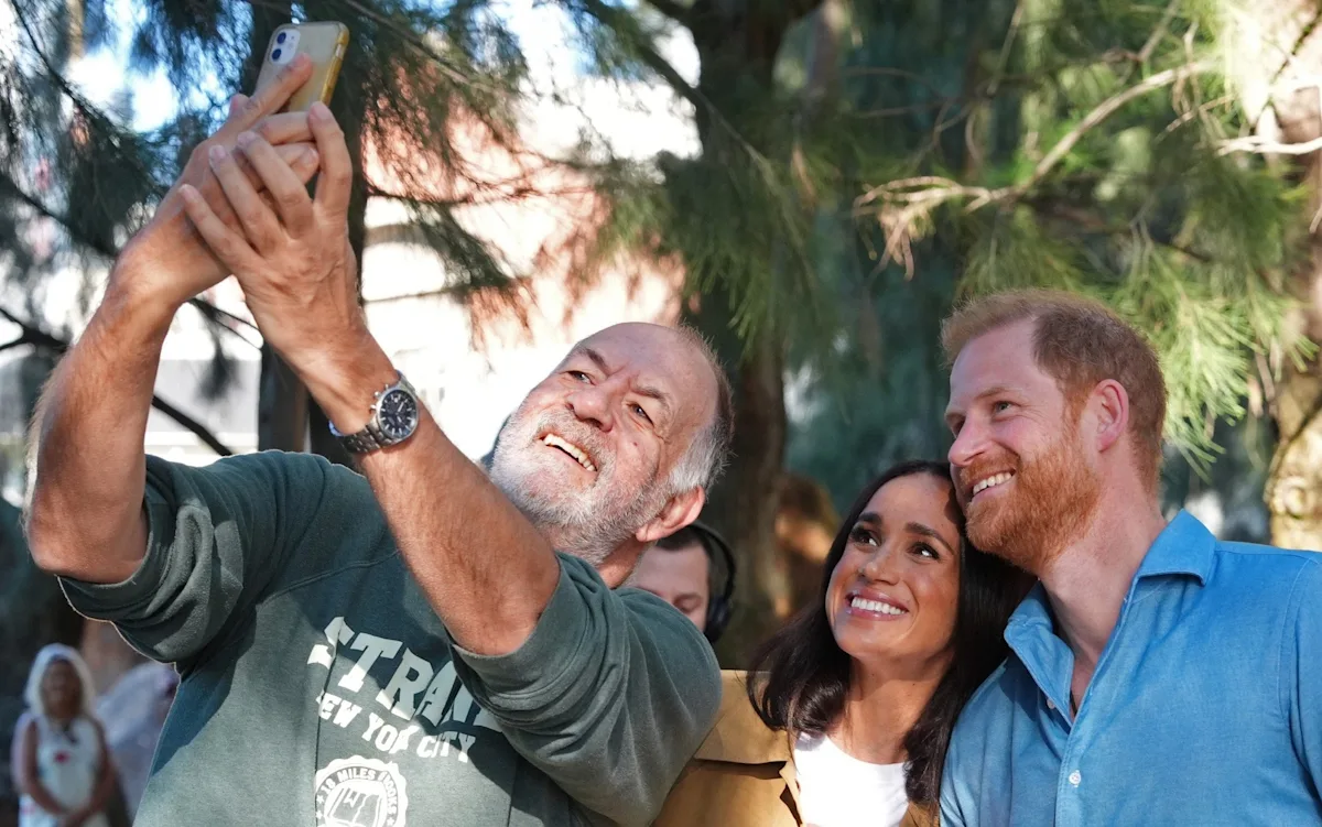 The Duke and Duchess of Sussex during their Australia tour, with a focus on their unconventional approach to royal duties and their ability to connect with the public, amidst the royal family's tradition and protocol, with the primary keyword being Royal Family