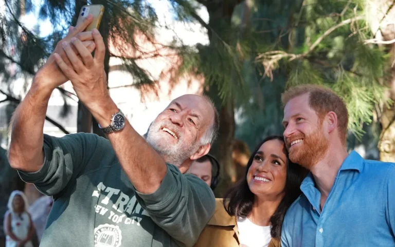The Duke and Duchess of Sussex during their royal tour of Australia, surrounded by crowds of well-wishers and media personnel, showcasing their unique approach to royal duties and their ability to connect with people from all walks of life, with a focus on their charitable work and commitment to making a positive impact on the world