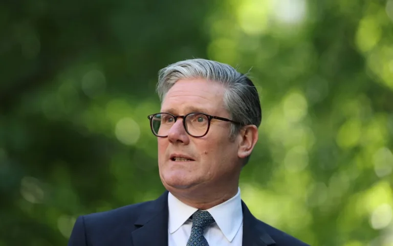Keir Starmer speaking in the House of Commons, with a focused expression, surrounded by other MPs, as the Labour Party navigates a significant challenge to its leadership, with the Commons rule threatening to undermine Starmer's authority, in the context of UK politics and political leadership